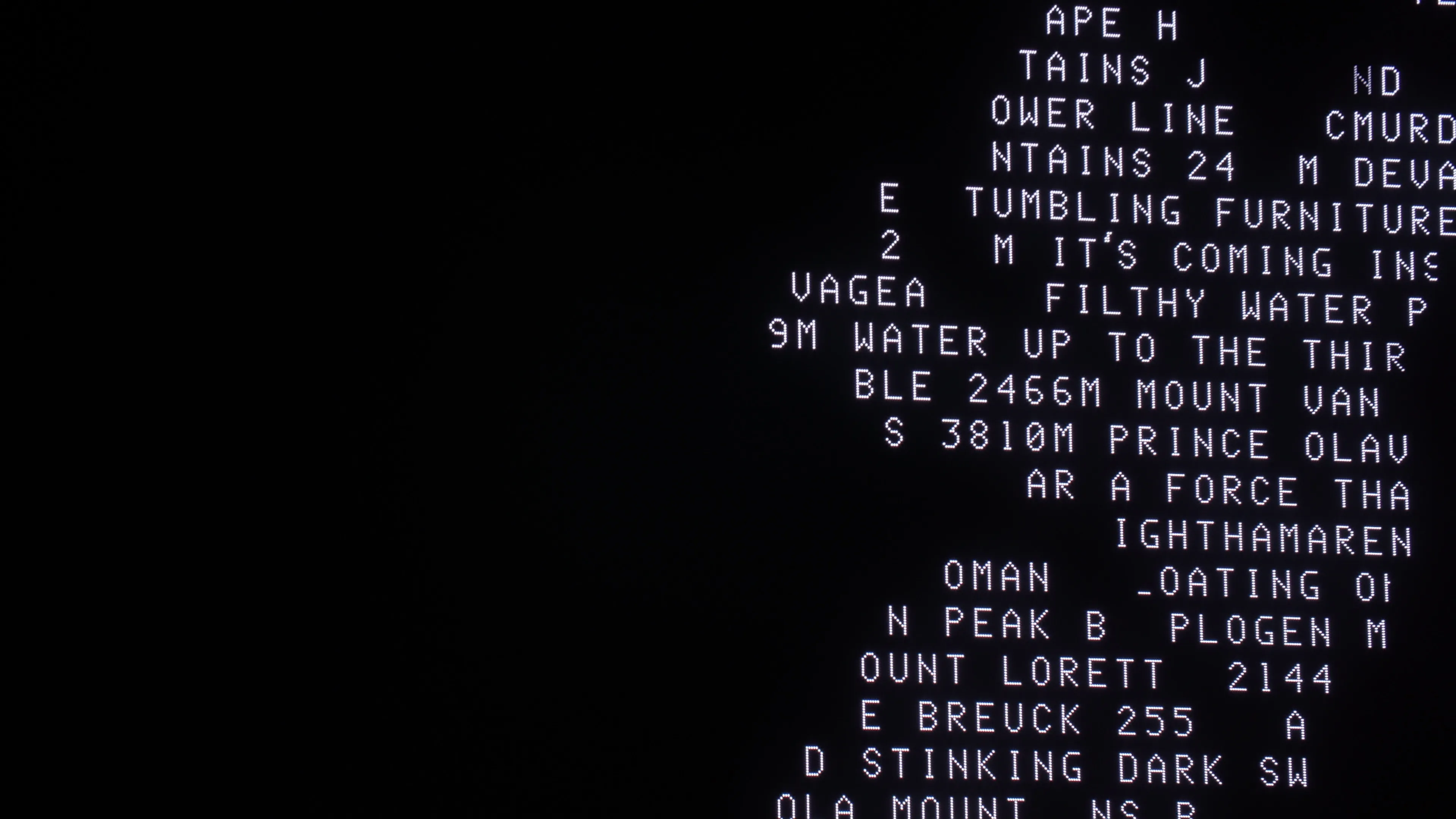 Pixelated white text on black that is displayed on an LED screen. The words are jumbled and mixed up.