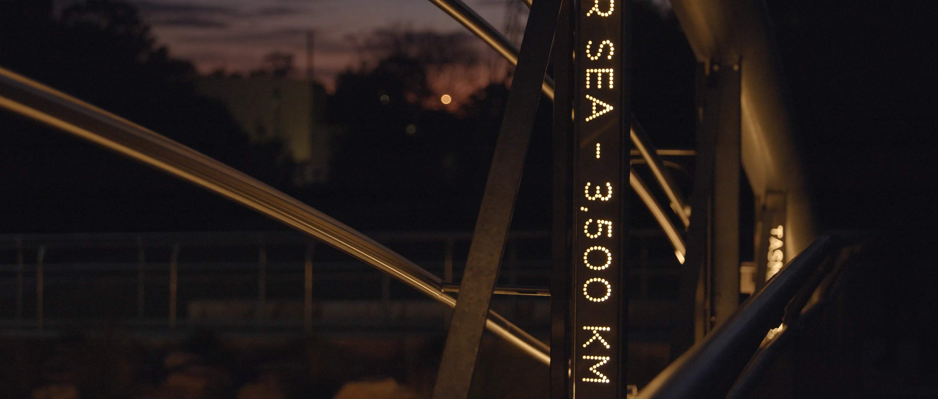 Close-up of Flyway showing illuminated distance markings integrated into the bridge structure.
