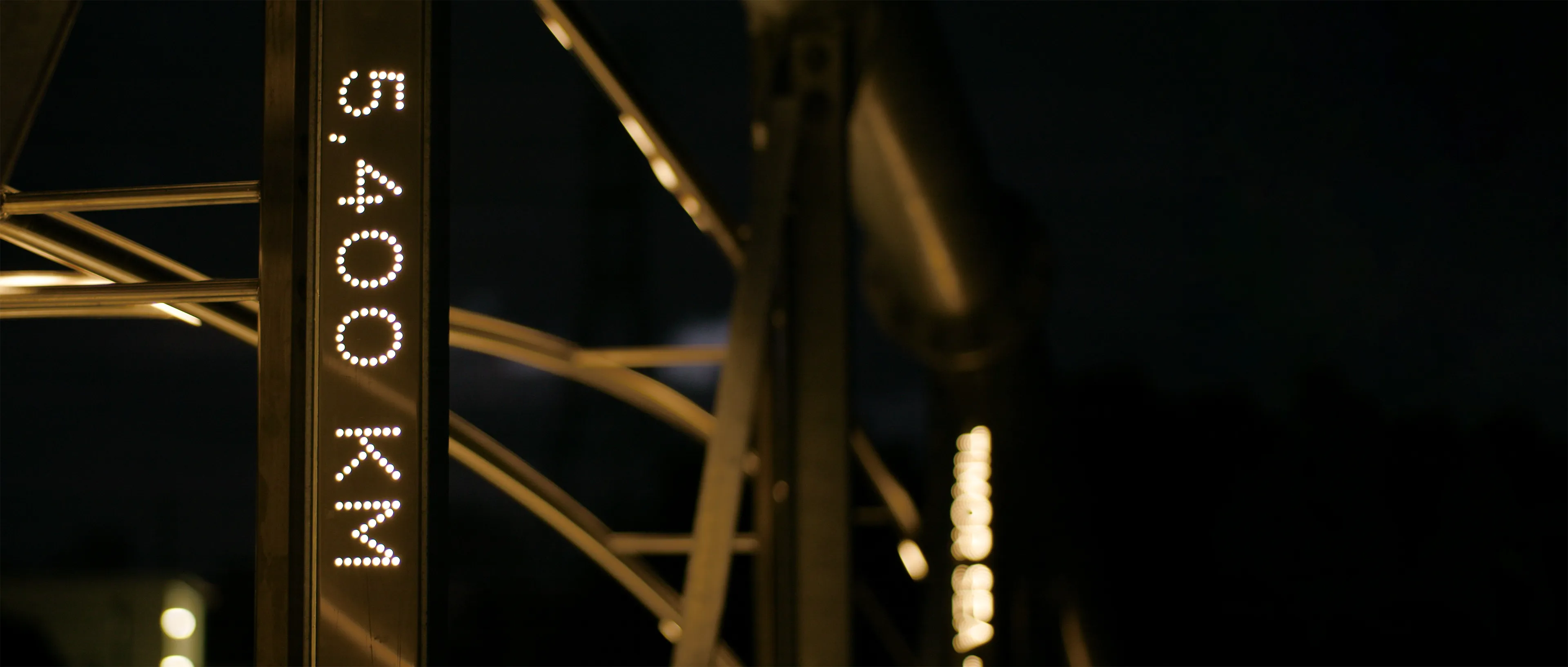 Close-up of an illuminated 5,400 KM distance marker in the Flyway installation.