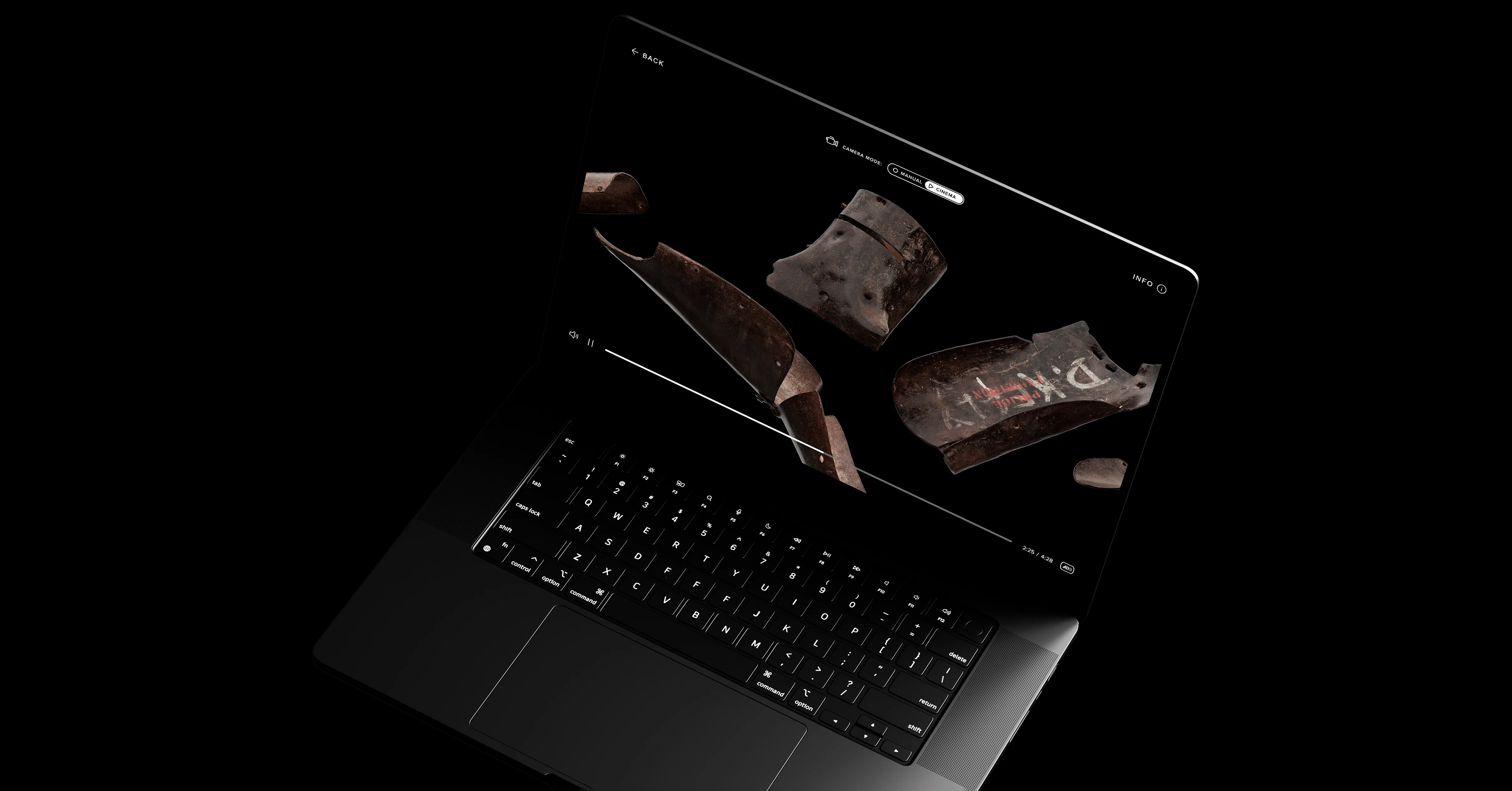 Open laptop displaying a 3D view of pieces of armour on the screen.