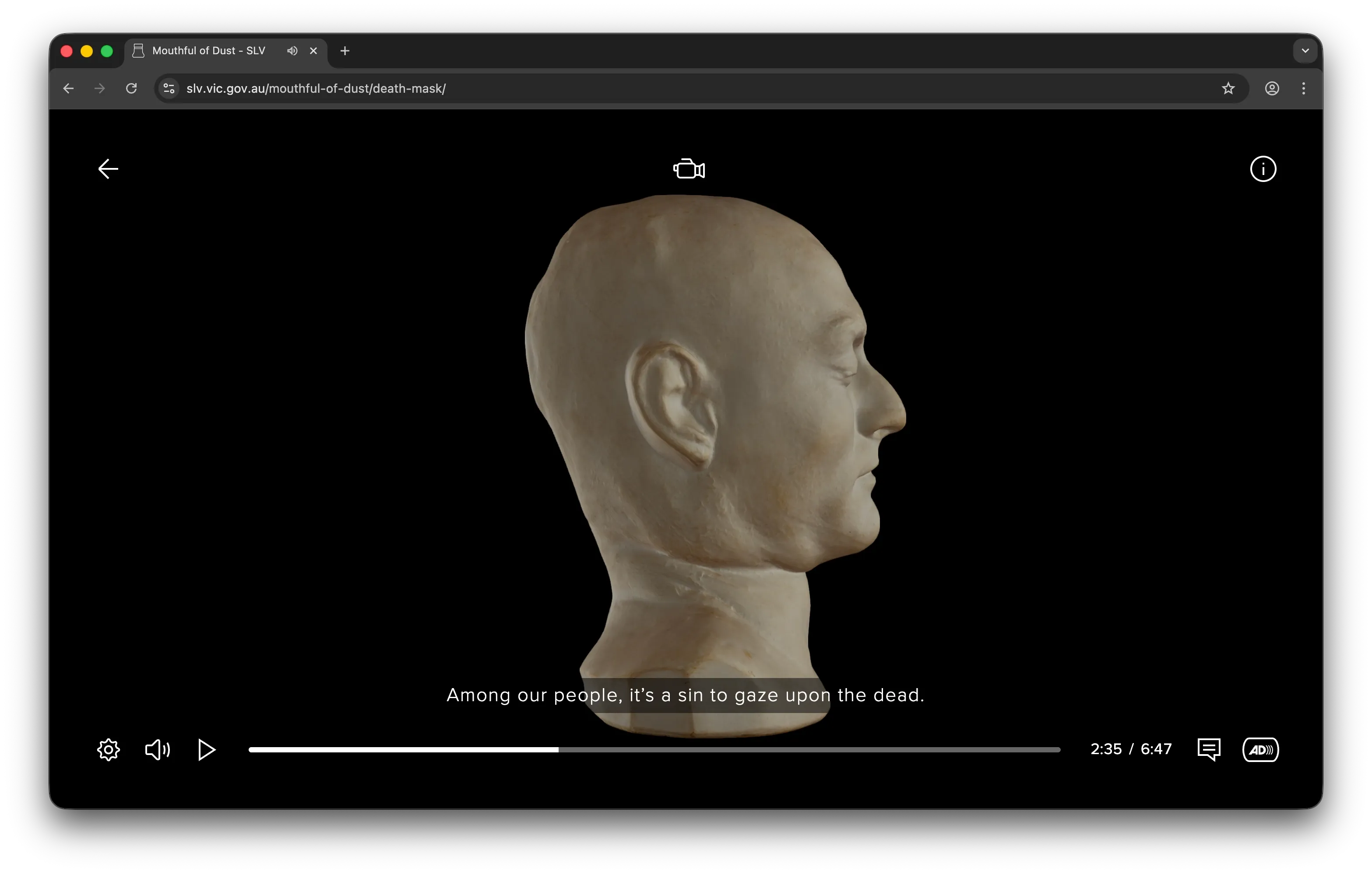 Side view of a pale, sculpted death mask against a black background with subtitle - 'Among our people, it's a sin to gaze upon the dead.'