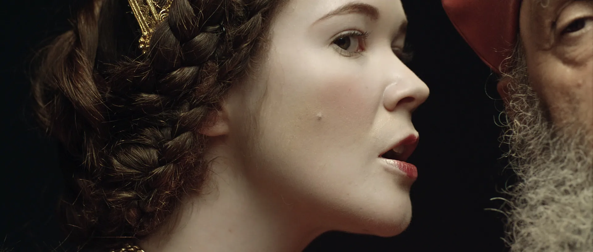 A queen whispering into the ear of a bishop.
