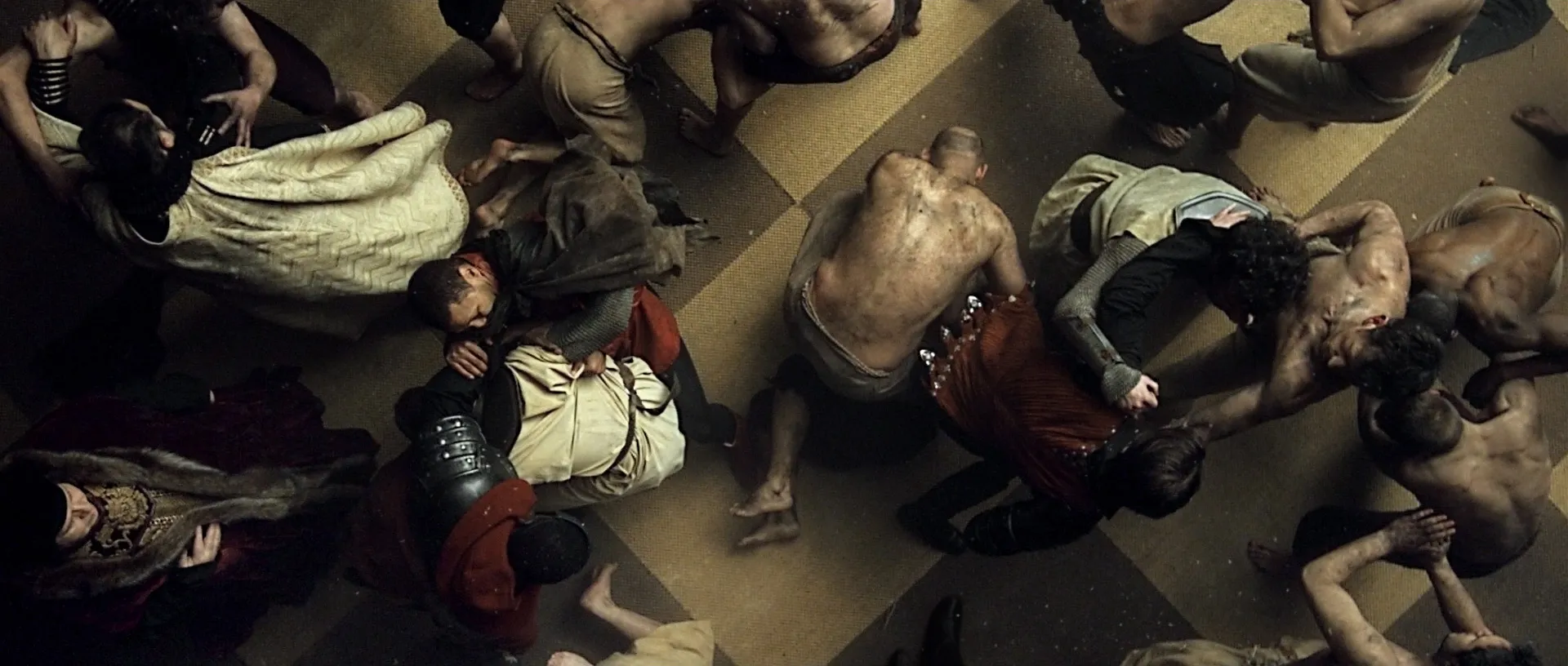 Aerial view looking down on about 20 people fighting in hand to hand combat.