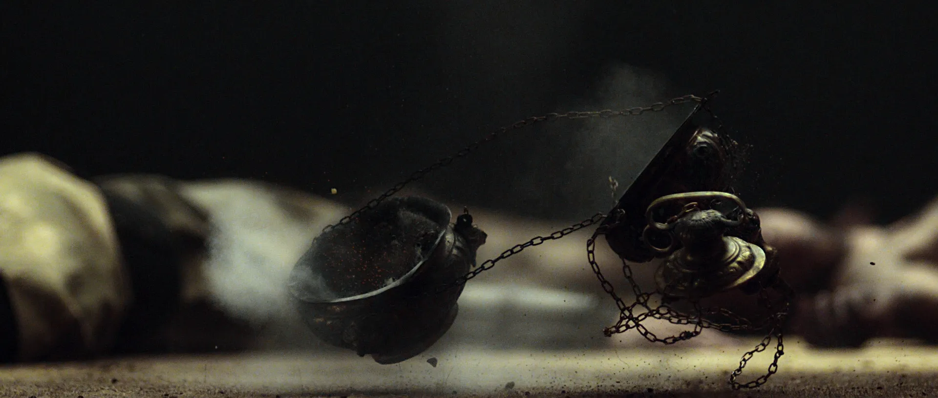 A falling thurible hitting the ground.