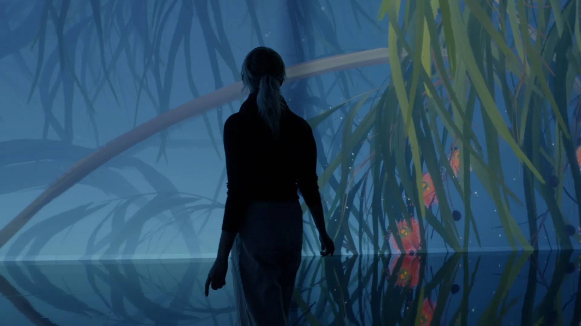 Visitor standing before an immersive projection of large plants and glowing forms in a blue environment.